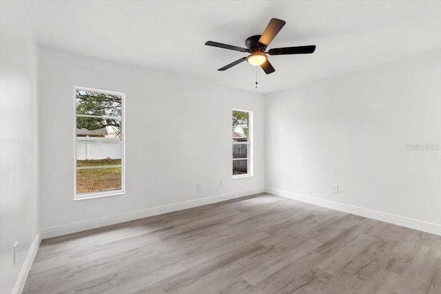 unfurnished room with ceiling fan and light wood-type flooring