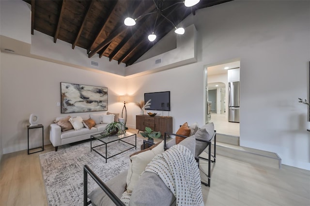 living room with beamed ceiling, light wood-type flooring, wood ceiling, and high vaulted ceiling