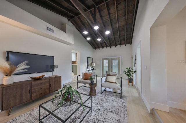 living room featuring light hardwood / wood-style floors, wooden ceiling, high vaulted ceiling, and french doors