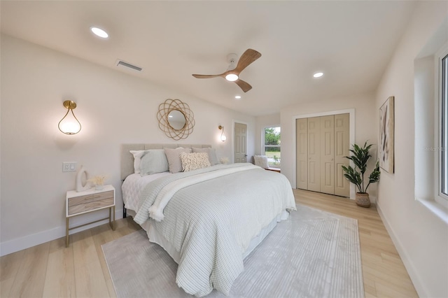 bedroom featuring a closet, ceiling fan, and light hardwood / wood-style flooring