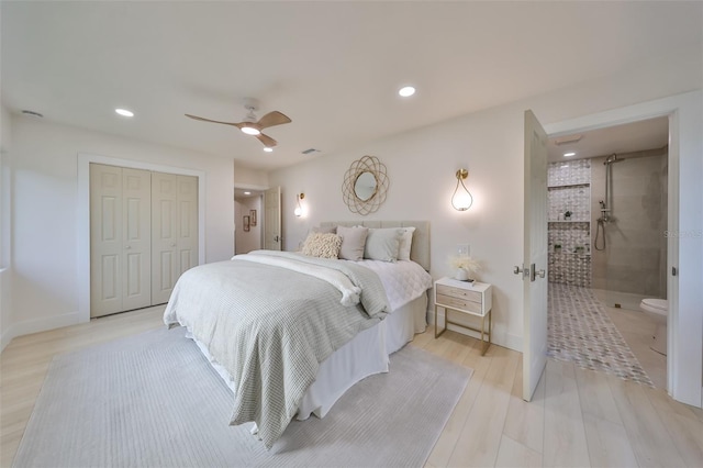 bedroom with ceiling fan, a closet, ensuite bathroom, and light wood-type flooring