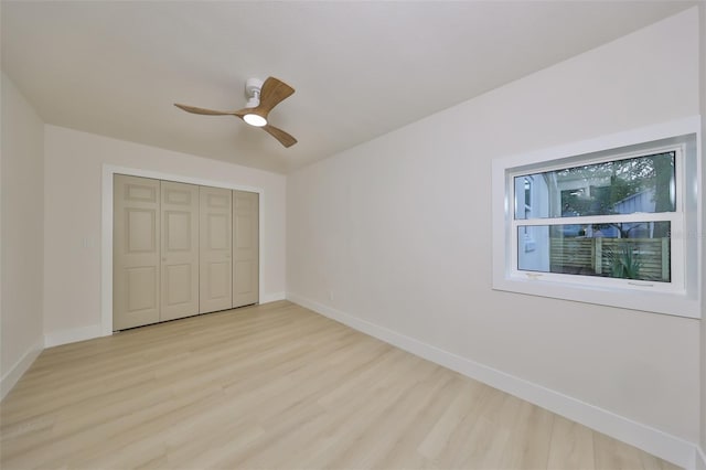 unfurnished bedroom featuring a closet, light hardwood / wood-style floors, and ceiling fan