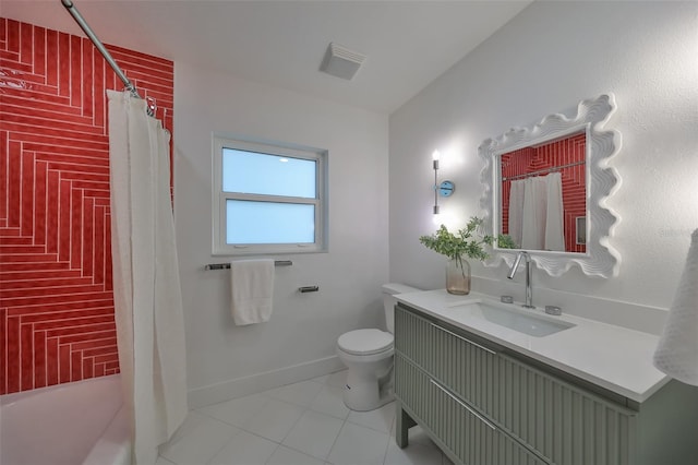 bathroom with tile patterned flooring, vanity, and toilet