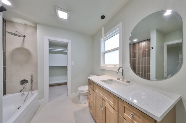 full bathroom featuring tile patterned floors, vanity, tiled shower / bath combo, and toilet