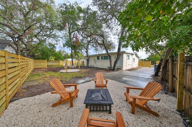 view of yard featuring a patio and an outdoor fire pit