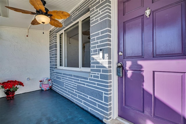 entrance to property featuring ceiling fan