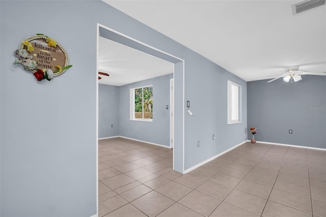 unfurnished room with plenty of natural light and light tile patterned floors