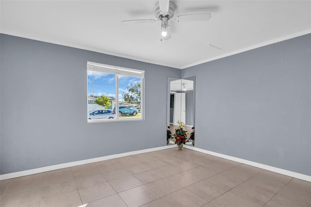 spare room featuring ceiling fan, light tile patterned floors, and ornamental molding