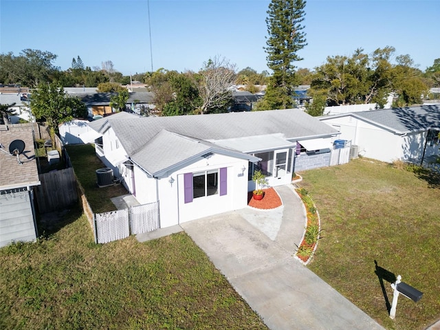 view of front of house featuring a front yard and central AC