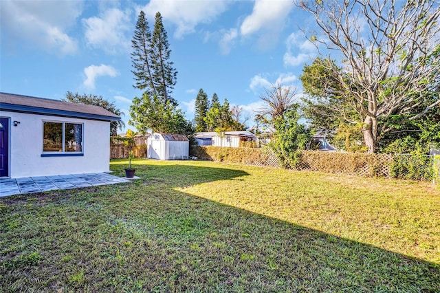 view of yard with a storage shed and a patio area