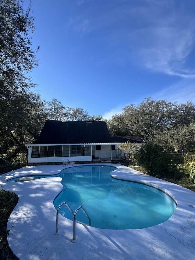 view of swimming pool with a patio area