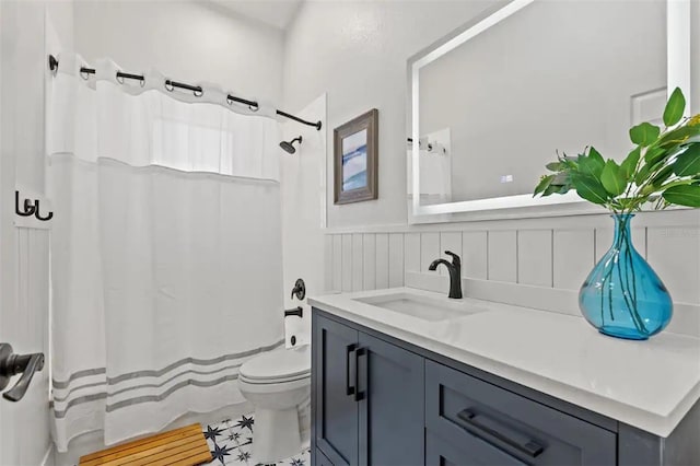 bathroom with curtained shower, vanity, and toilet