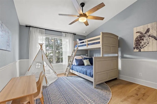 bedroom with hardwood / wood-style floors, ceiling fan, and lofted ceiling