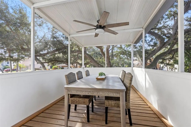 sunroom / solarium with ceiling fan and vaulted ceiling