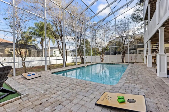 view of swimming pool featuring a lanai and a patio area