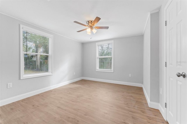 empty room featuring ceiling fan, light hardwood / wood-style floors, and crown molding