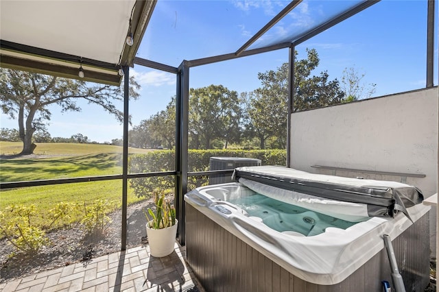 sunroom / solarium featuring a jacuzzi