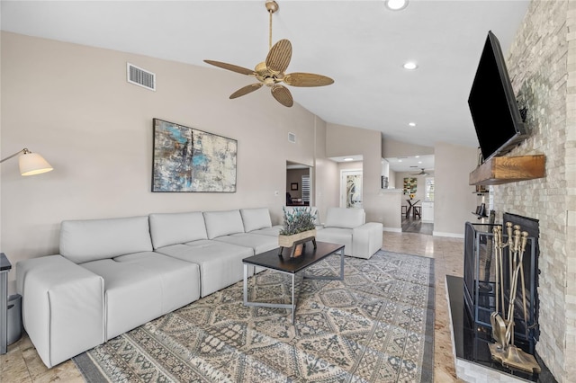 living room with ceiling fan, high vaulted ceiling, and a brick fireplace