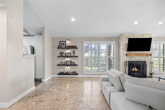 living room with a stone fireplace