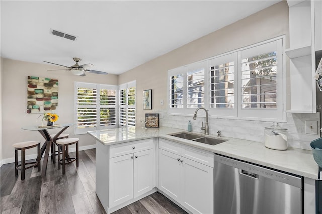 kitchen with dishwasher, white cabinets, sink, dark hardwood / wood-style floors, and kitchen peninsula