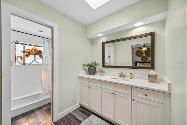 bathroom with a shower with shower curtain, vanity, hardwood / wood-style flooring, and ceiling fan