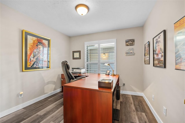 home office with dark hardwood / wood-style flooring and a textured ceiling