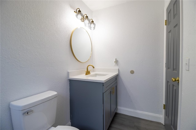 bathroom with vanity, hardwood / wood-style flooring, and toilet