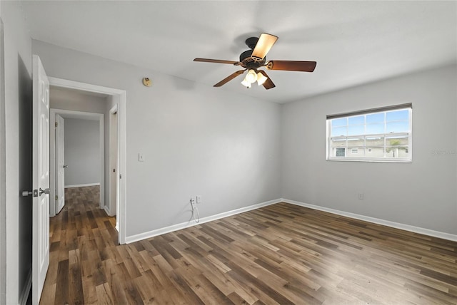 unfurnished room featuring ceiling fan and dark hardwood / wood-style floors