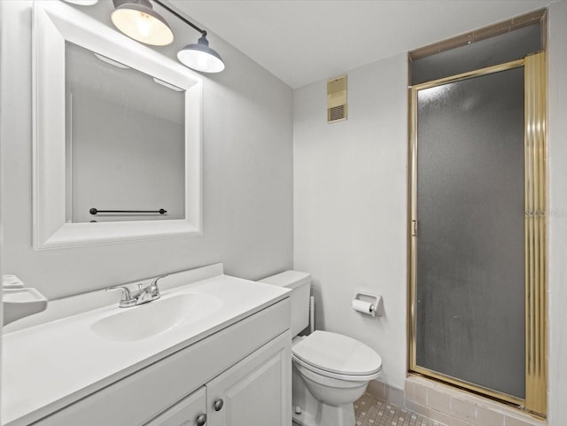 bathroom featuring tile patterned floors, a shower with door, vanity, and toilet