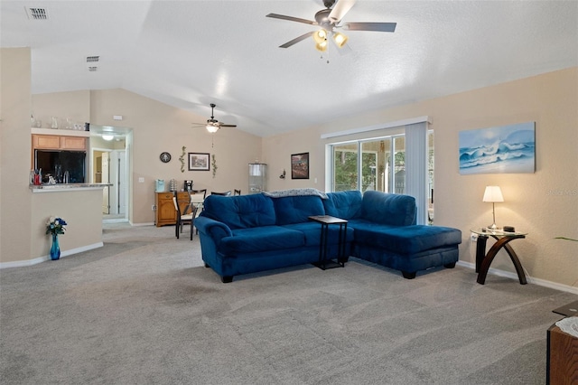 carpeted living room featuring ceiling fan and vaulted ceiling