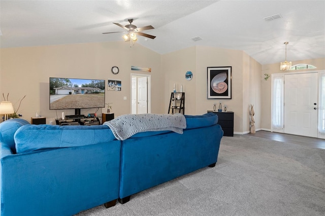 living room with carpet flooring, ceiling fan with notable chandelier, and lofted ceiling