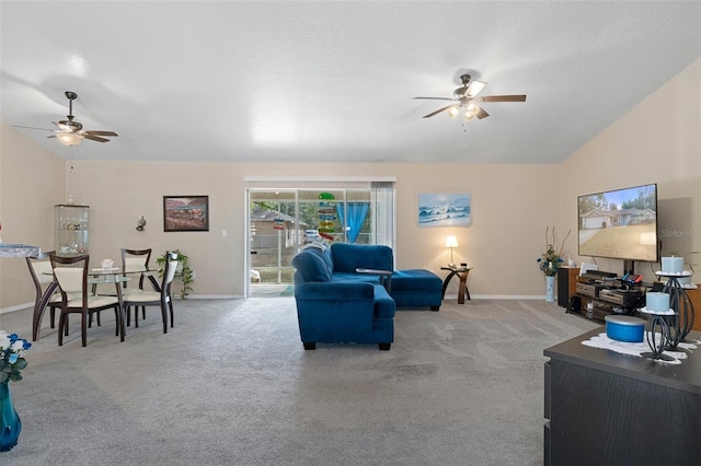 living room featuring carpet floors, ceiling fan, and lofted ceiling