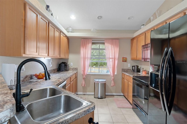 kitchen with sink, light tile patterned flooring, and black appliances