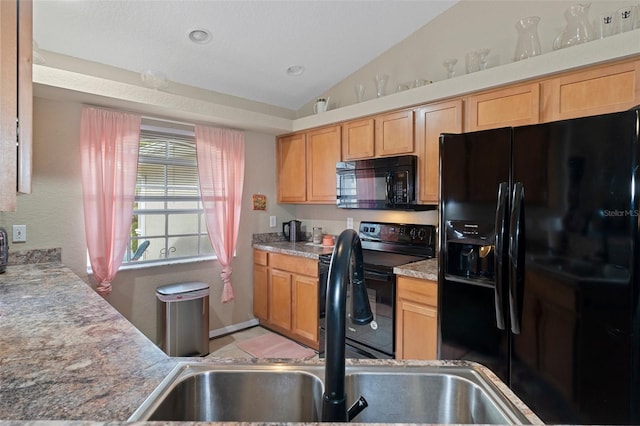 kitchen featuring black appliances, sink, and vaulted ceiling