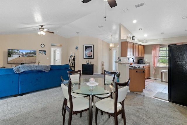 dining space featuring light colored carpet, vaulted ceiling, ceiling fan, and sink