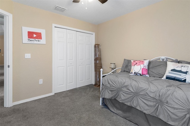 carpeted bedroom with ceiling fan and a closet