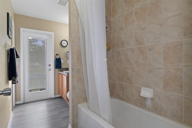 bathroom featuring shower / tub combo with curtain, vanity, and hardwood / wood-style flooring