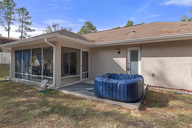 rear view of property featuring a sunroom