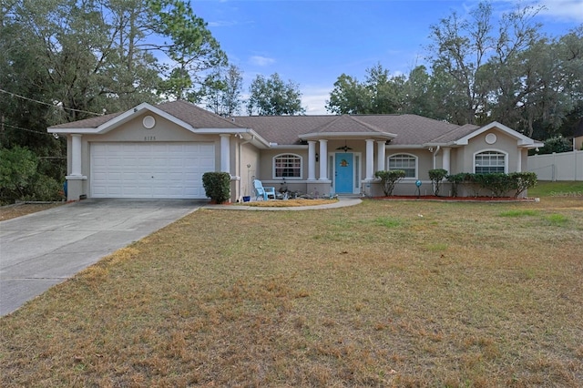 ranch-style house with a garage and a front lawn