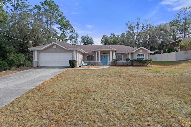 ranch-style house with a garage and a front lawn