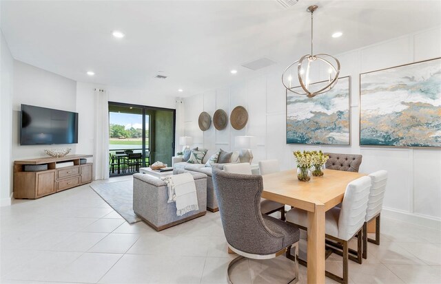 tiled dining space with a chandelier