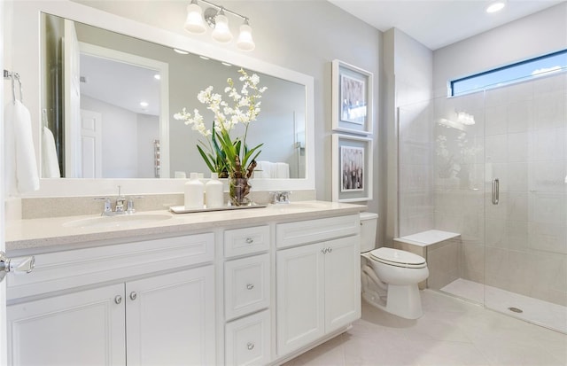 bathroom with tile patterned floors, vanity, an enclosed shower, and toilet