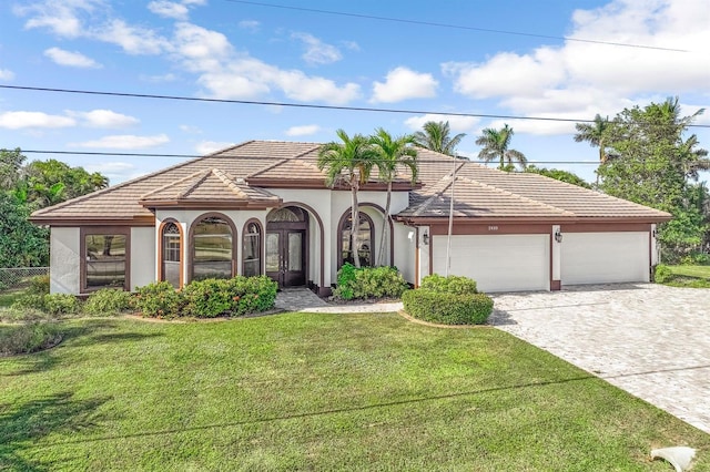 view of front of property featuring a garage and a front lawn