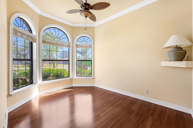 spare room featuring hardwood / wood-style floors, a wealth of natural light, and ornamental molding