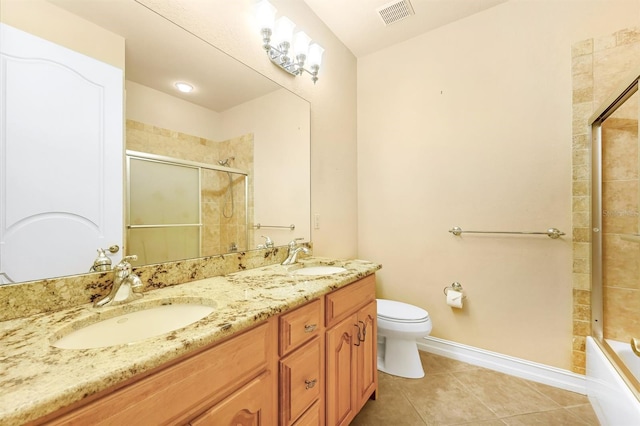 full bathroom featuring tile patterned floors, vanity, bath / shower combo with glass door, and toilet