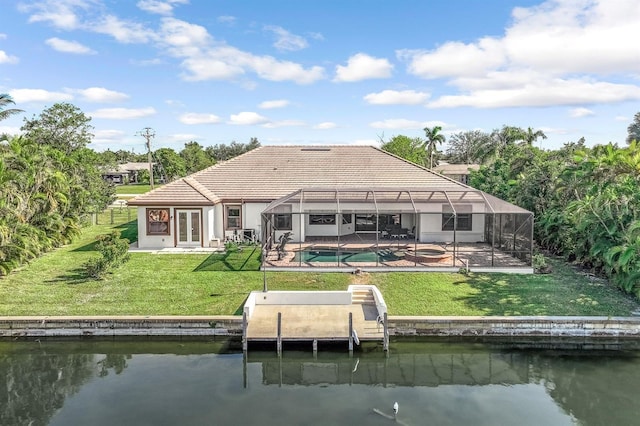 back of property featuring glass enclosure, a water view, a yard, and a patio