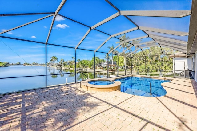 view of pool with a lanai, a patio area, an in ground hot tub, and a water view