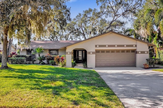 ranch-style house featuring a front lawn and a garage