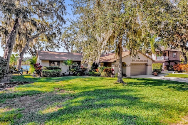 view of front of property with a front lawn and a garage