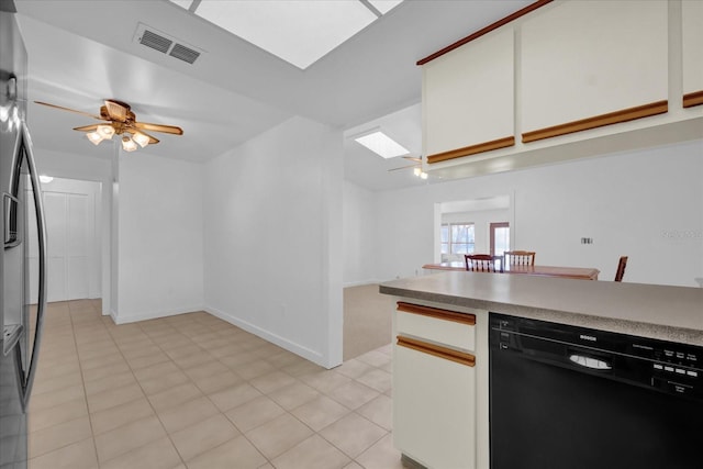 kitchen with stainless steel fridge, ceiling fan, black dishwasher, light tile patterned flooring, and white cabinets